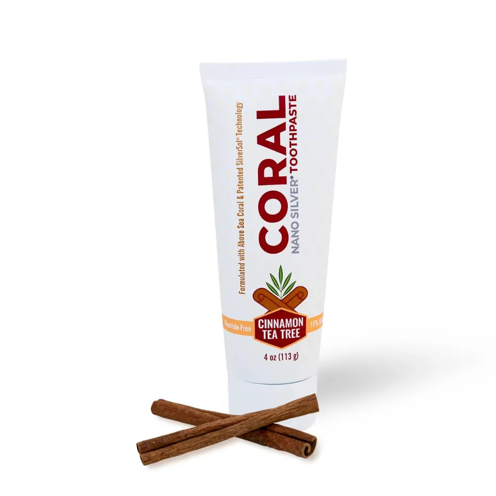 Tube of Coral Nano Silver Toothpaste with cinnamon sticks on a white background