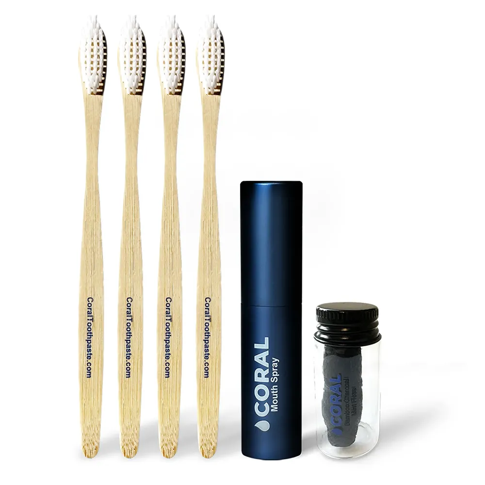Set of four bamboo toothbrushes and two mouthwash containers on a white background