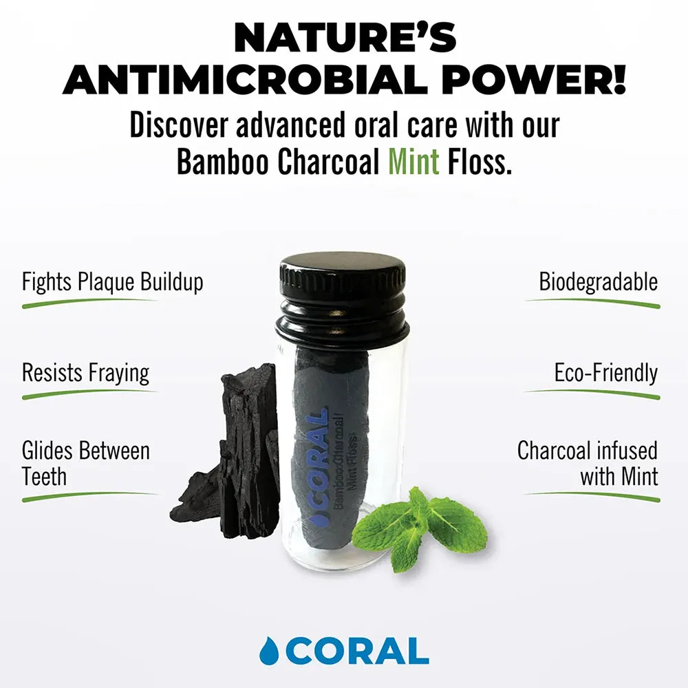 Coral Bamboo Charcoal Mint Floss in eco-friendly glass container with charcoal and mint leaves, biodegradable antimicrobial dental floss that fights plaque and glides smoothly between teeth.