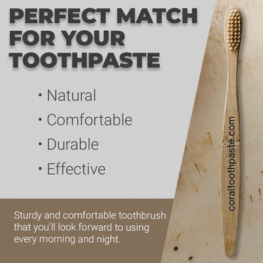 Eco-friendly bamboo toothbrush from Coral Toothpaste shown on a natural background. Features soft bristles and ergonomic wooden handle engraved with coraltoothpaste.com. Promotes a natural, durable, and comfortable brushing experience — the perfect sustainable match for Coral Nano Silver Toothpaste.