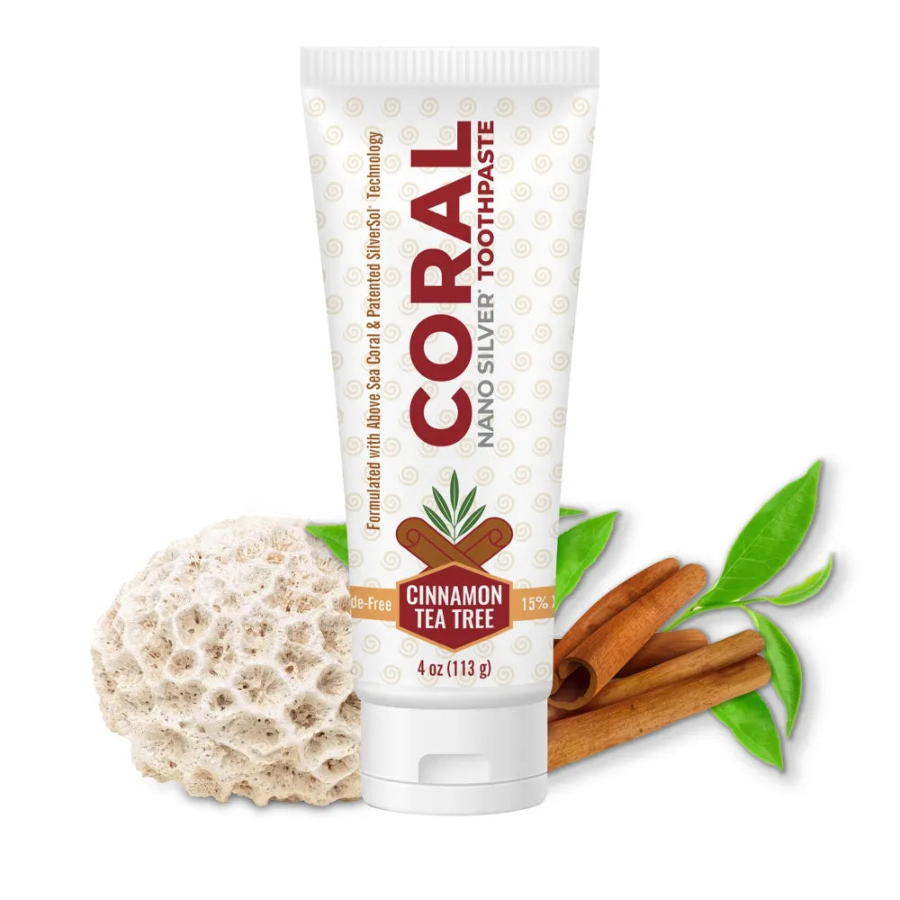 Coral Nano Silver Toothpaste tube with a fossilixed coral, cinnamon sticks, and tea tree leaves on a white background