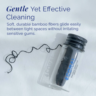 Coral bamboo charcoal mint floss shown in reusable glass container, designed for gentle yet effective cleaning between teeth without irritating sensitive gums.