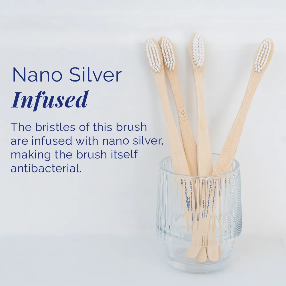 All-natural bamboo toothbrush for adults with nano silver–infused bristles, displayed in a clear glass holder, designed for antibacterial oral care