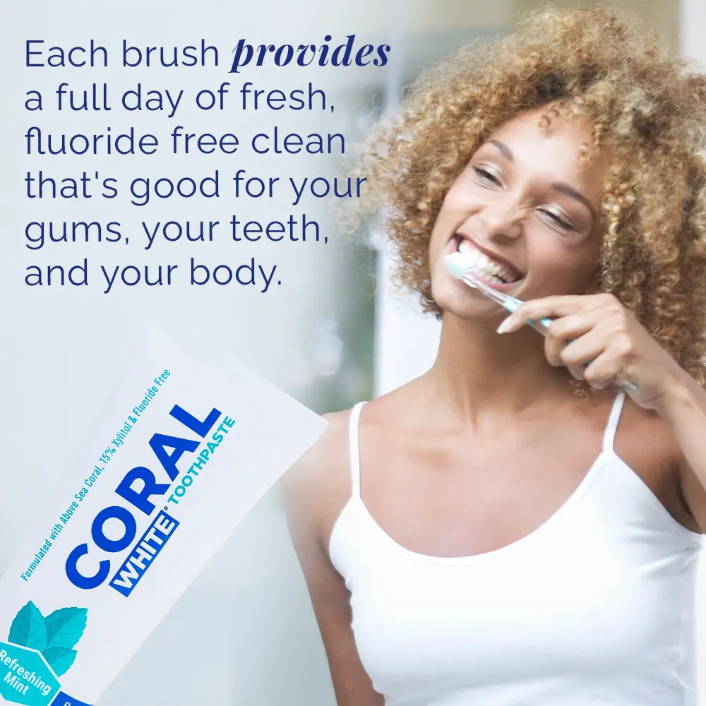 Woman brushing her teeth with Coral White toothpaste packaging in the foreground