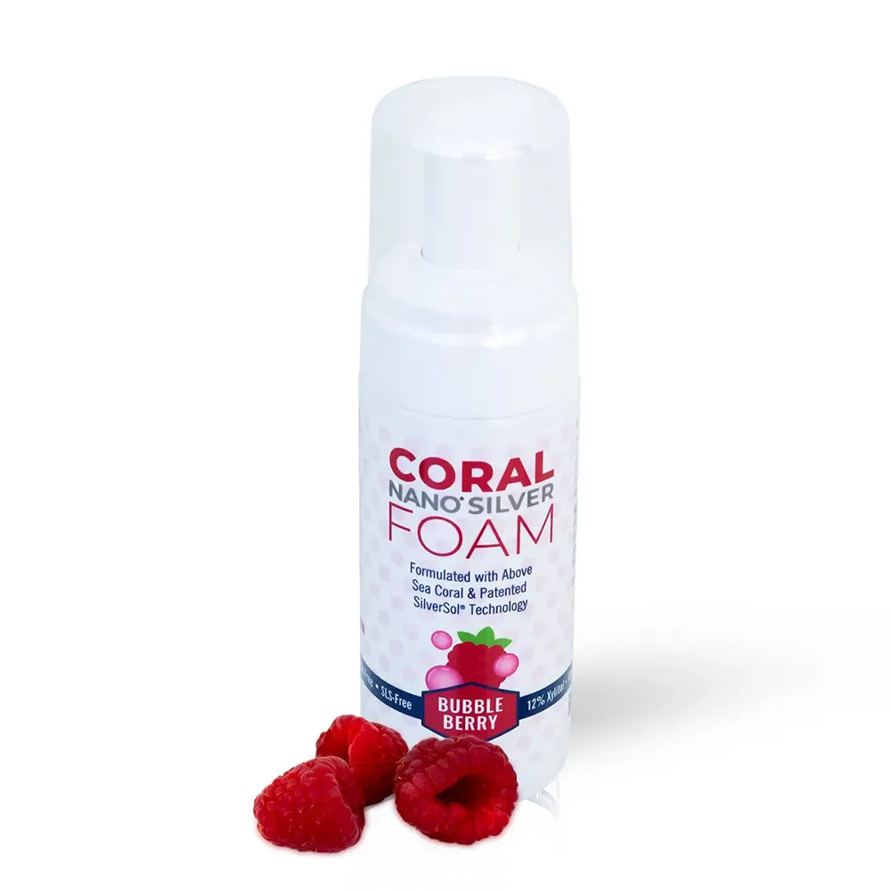 Coral Nano Silver foaming Bubble Berry toothpaste in a 4.2 fl oz white pump bottle, formulated with above sea coral and patented SilverSol technology, displayed with fresh raspberries on a white background.