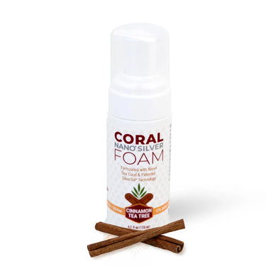 Coral Nano Silver foaming Cinnamon Tea Tree toothpaste in a 4.2 fl oz (125ml) white pump bottle with cinnamon sticks, featuring a clean white background. Formulated with above sea coral and patented SilverSol technology.