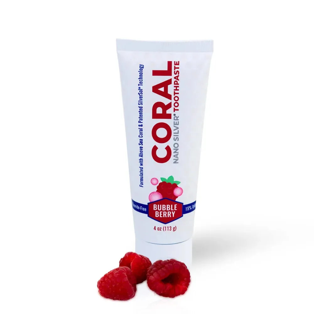 Tube of Coral Nano Silver Toothpaste with raspberries on a white background
