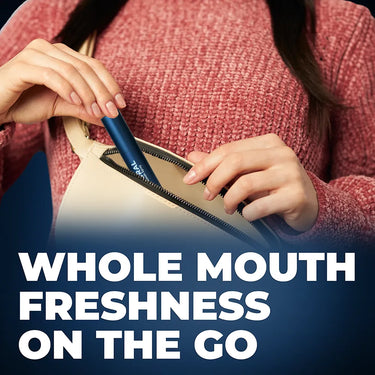 Woman placing Coral Mouth Spray into beige handbag with text “Whole mouth freshness on the go.” Highlights portable, eco-friendly oral care for instant fresh breath and clean teeth anytime, anywhere.