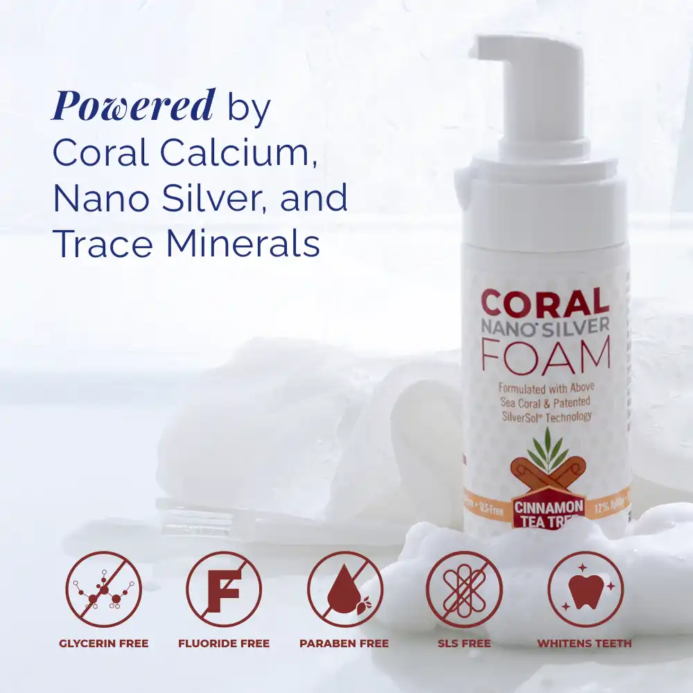 Coral Nano Silver Foaming Toothpaste Cinnamon Tea Tree flavor bottle with foam background and icons highlighting benefits: glycerin-free, fluoride-free, paraben-free, SLS-free, and whitens teeth. Text reads: Powered by coral calcium, nano silver, and trace minerals. Natural fluoride-free oral care with above sea coral and SilverSol technology.