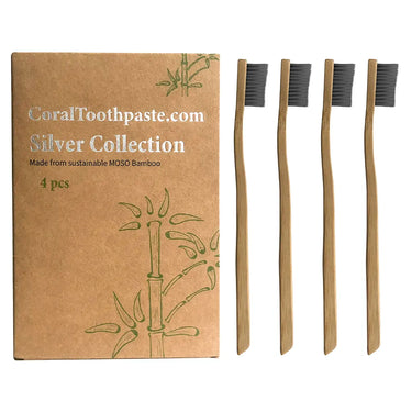 Bamboo toothbrushes with packaging labeled 'CoralToothpaste.com Silver Collection' on a white background.