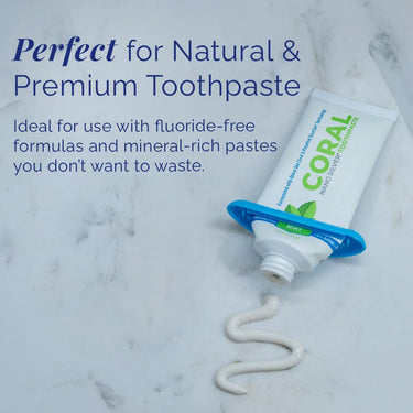Handy toothpaste squeezer used with a fluoride-free, mineral-rich toothpaste tube to prevent waste, shown dispensing Coral Nano Silver Toothpaste on a marble surface