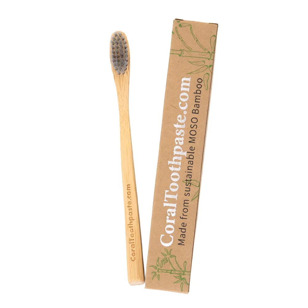All-natural bamboo toothbrush with nano silver–infused bristles shown beside sustainable MOSO bamboo packaging, designed for eco-friendly daily oral care
