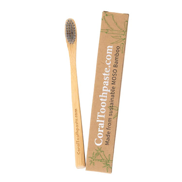 All-natural bamboo toothbrush with nano silver–infused bristles shown beside sustainable MOSO bamboo packaging, designed for eco-friendly daily oral care