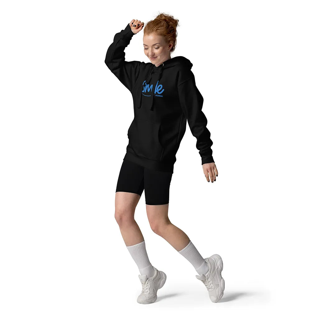 Person wearing a black hoodie with 'Smile' text, black shorts, white socks, and white sneakers on a white background