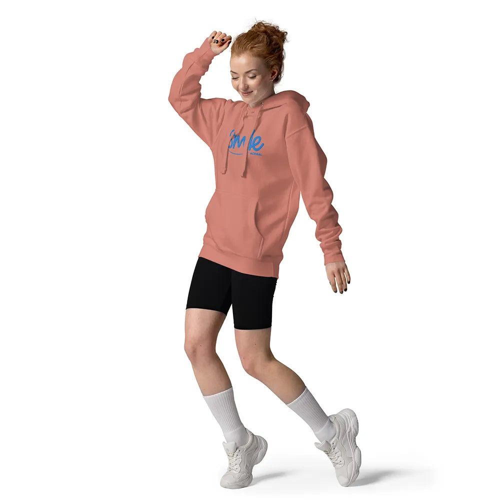 Person wearing a pink hoodie with text, black shorts, white socks, and white sneakers on a white background