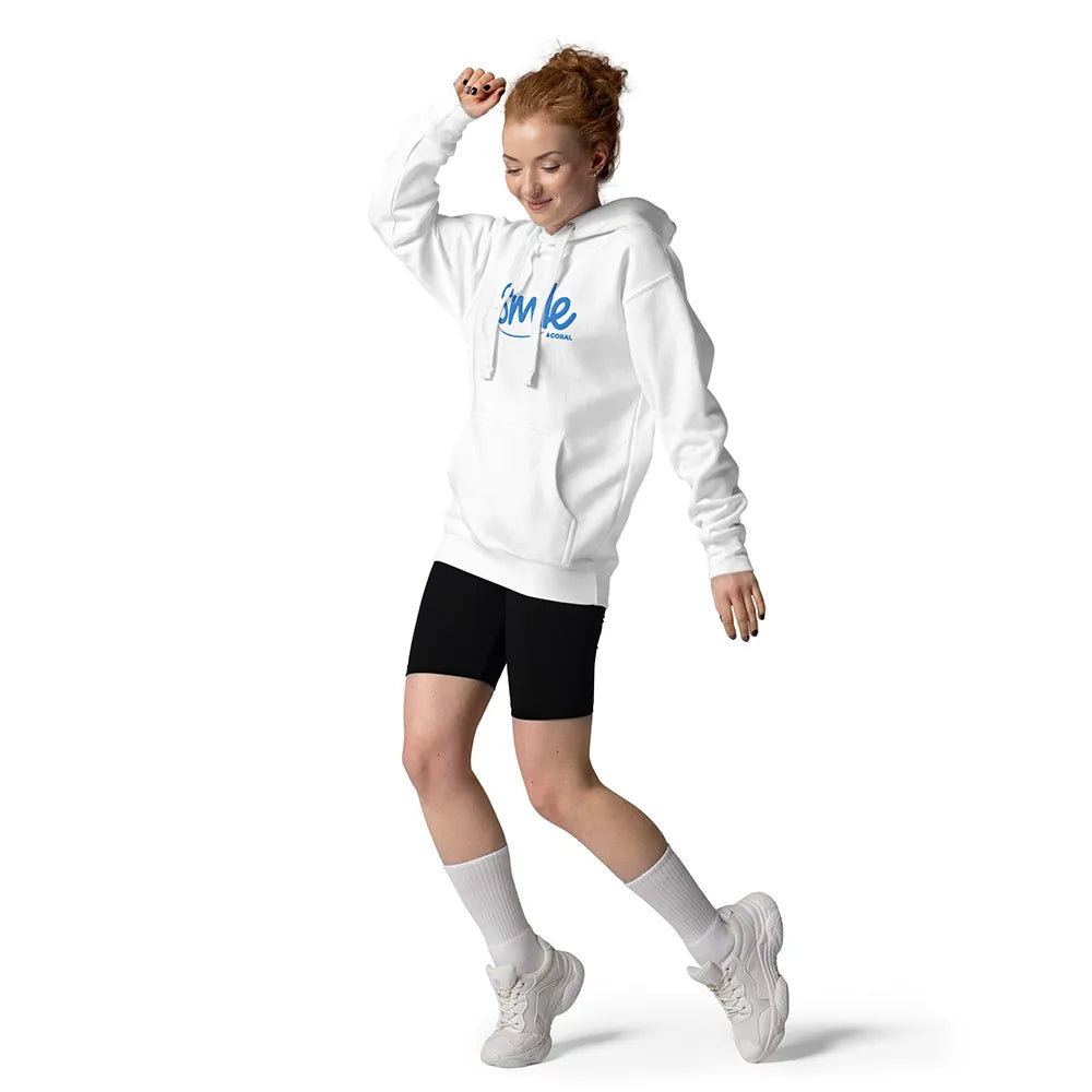 Person wearing a white hoodie with 'Smile' text, black shorts, and white sneakers on a white background