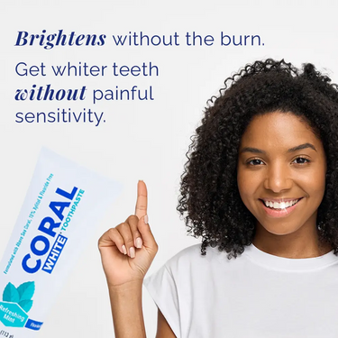 Woman pointing to Coral White toothpaste with text about teeth whitening.