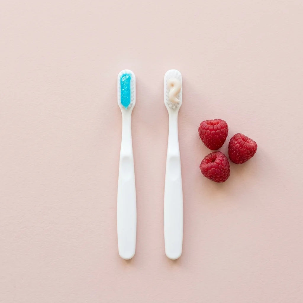 Illustration: a toothbrush with neon blue gel beside one with plain natural paste